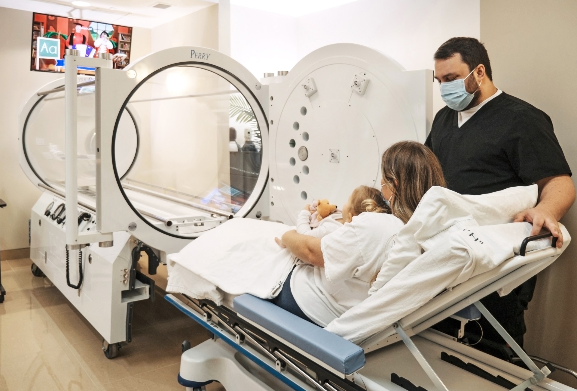 Patient inside a hyperbaric oxygen therapy chamber in a clinical setting